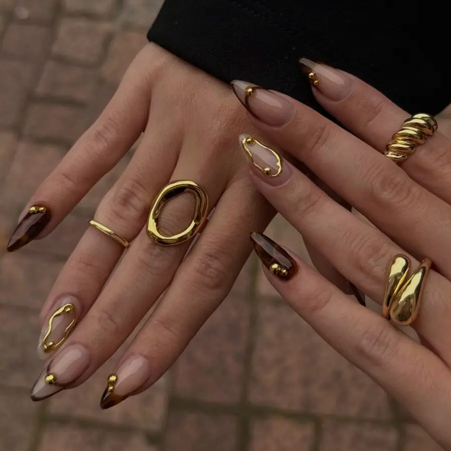 Elegant fall nails with golden accents and shapes