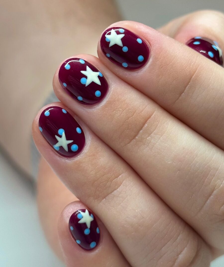 Charming maroon nails adorned with blue accents