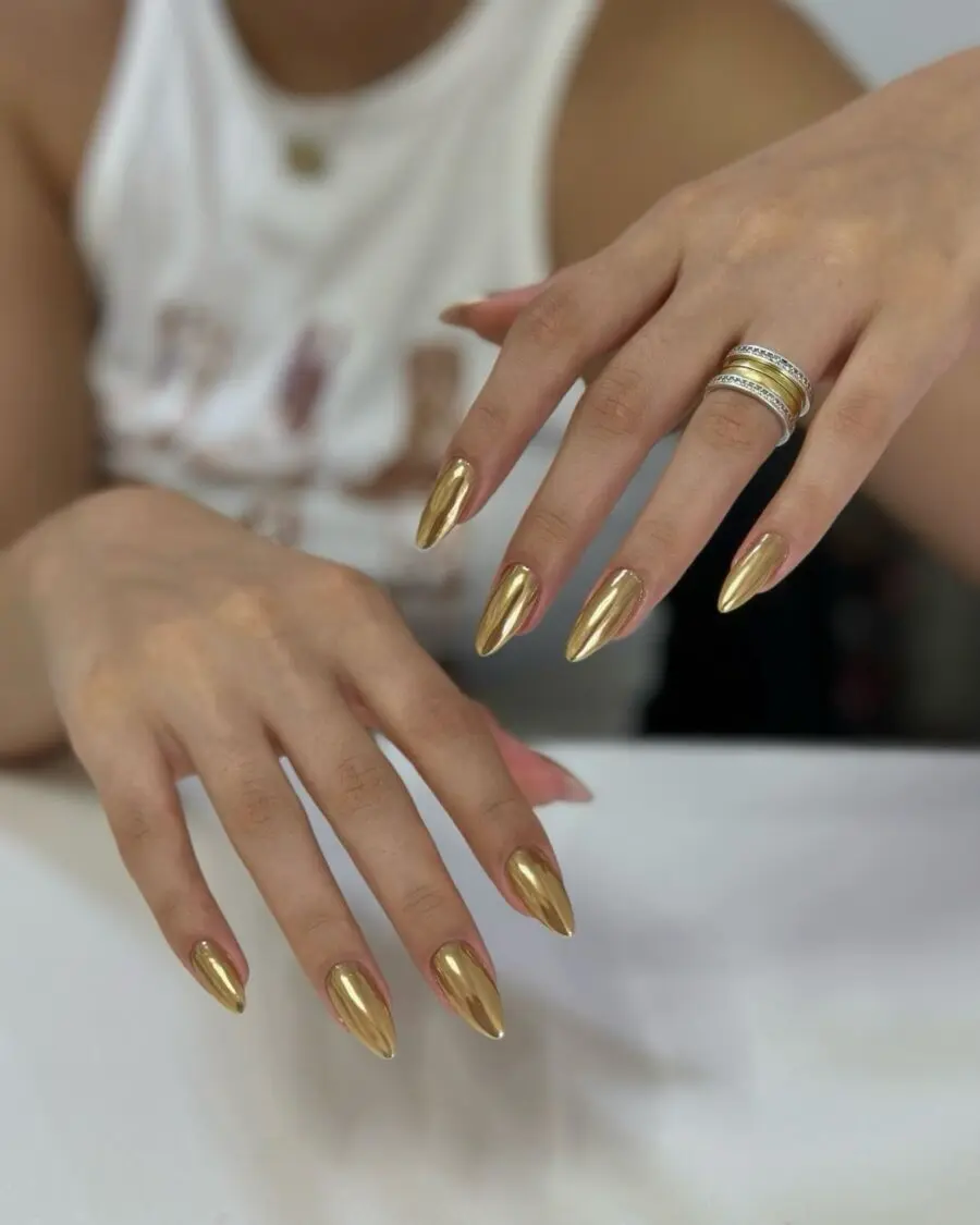 Glamorous golden stiletto nails in focus