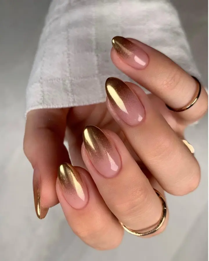 Elegant golden ombre nail design with shine