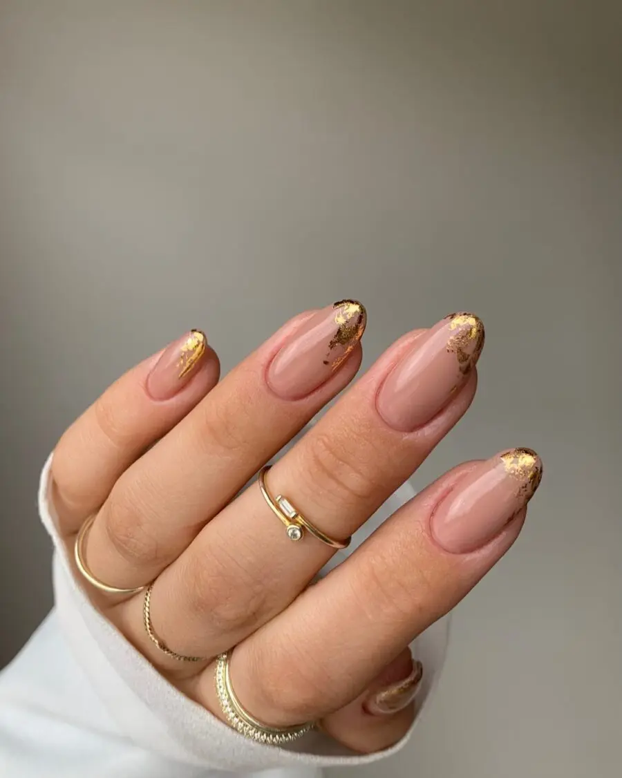 Elegant gold-tipped nails on a soft pink base