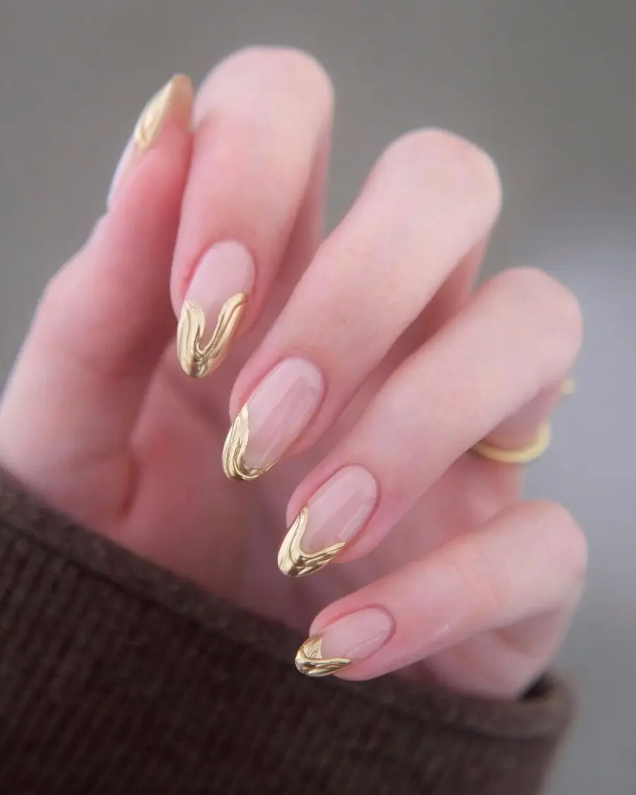 Elegant gold wave design on nude nails