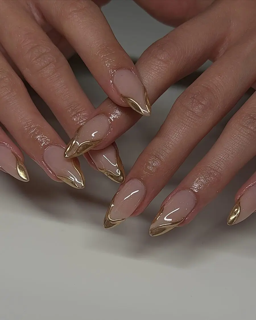 Elegant gold-studded stiletto nails showcase style.