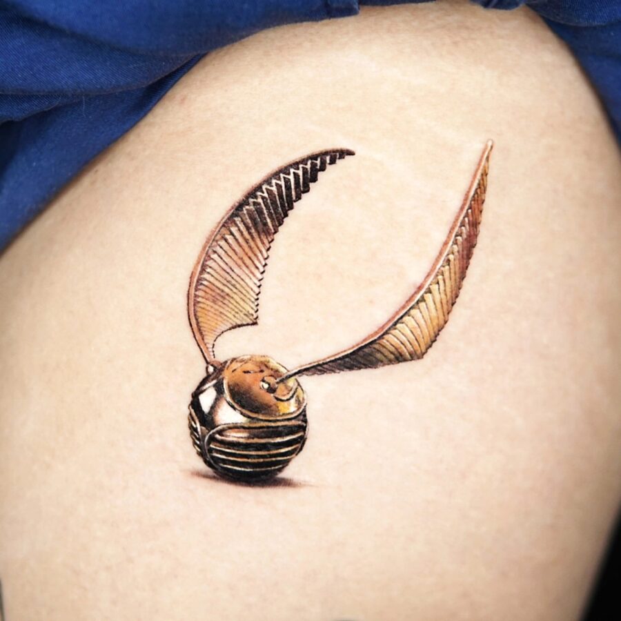 Stunning realistic Golden Snitch tattoo design