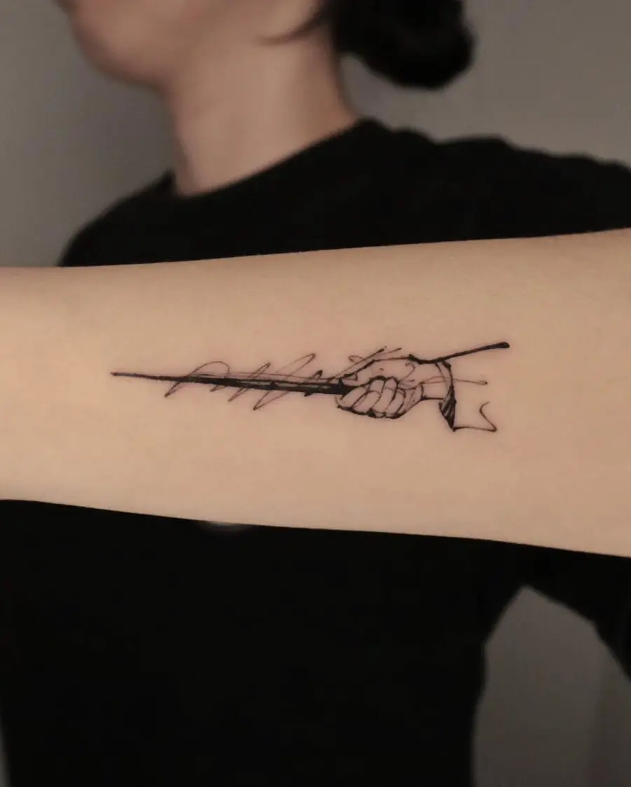 Minimalist Wand Tattoo Symbolizing Magic and Strength