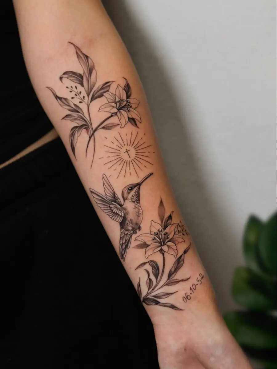 Elegant hummingbird memorial tattoo featuring floral elements