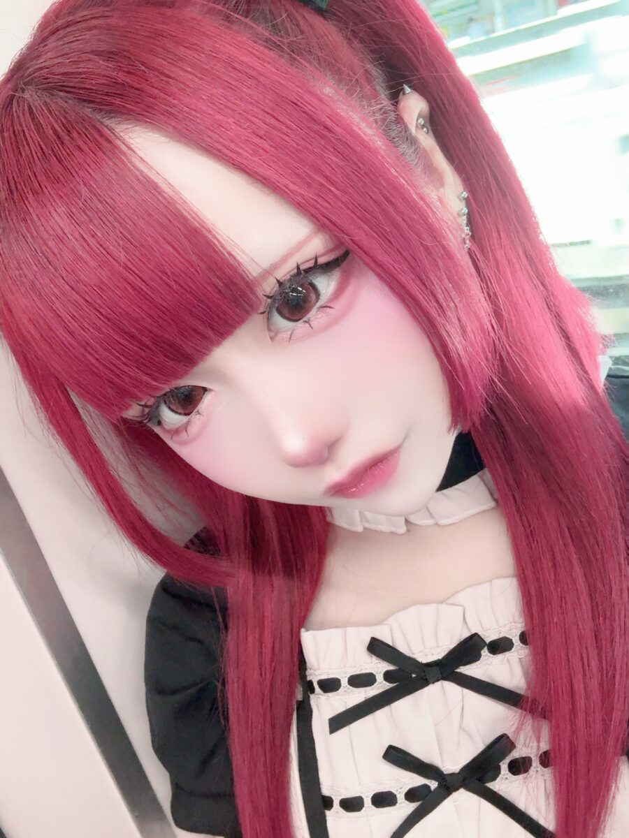 Vibrant pink hair with soft, doll-like makeup