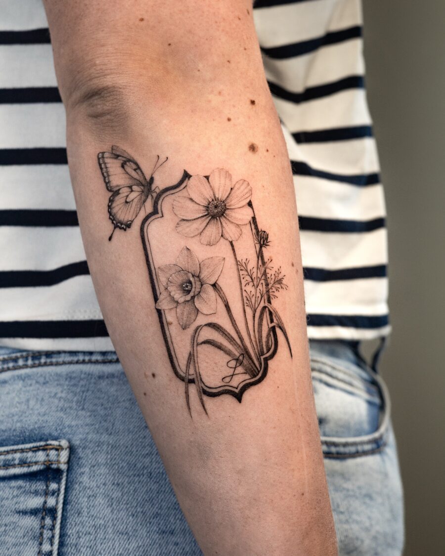 Elegant floral memorial tattoo with butterfly design