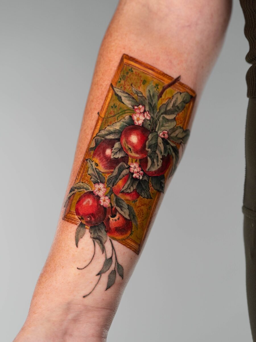 Vibrant memorial tattoo featuring fruit and flowers