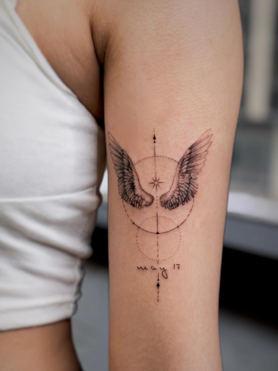 Elegant wings tattoo with a personal touch