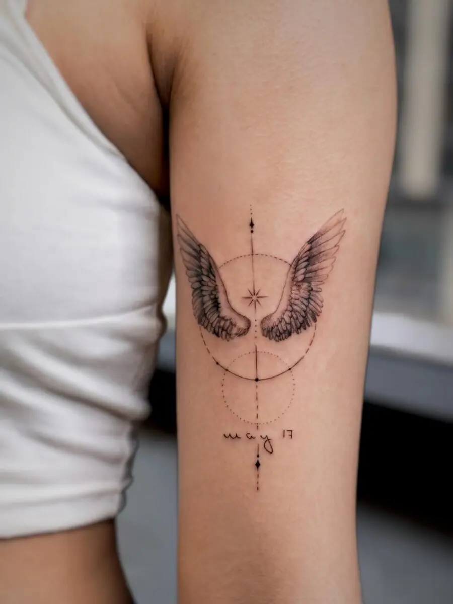 Elegant wings tattoo with a personal touch