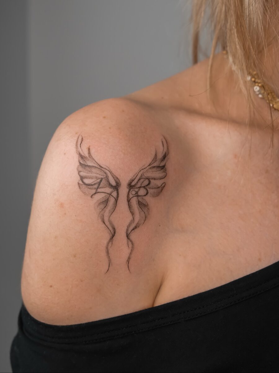 Elegant wing tattoo honoring cherished memories