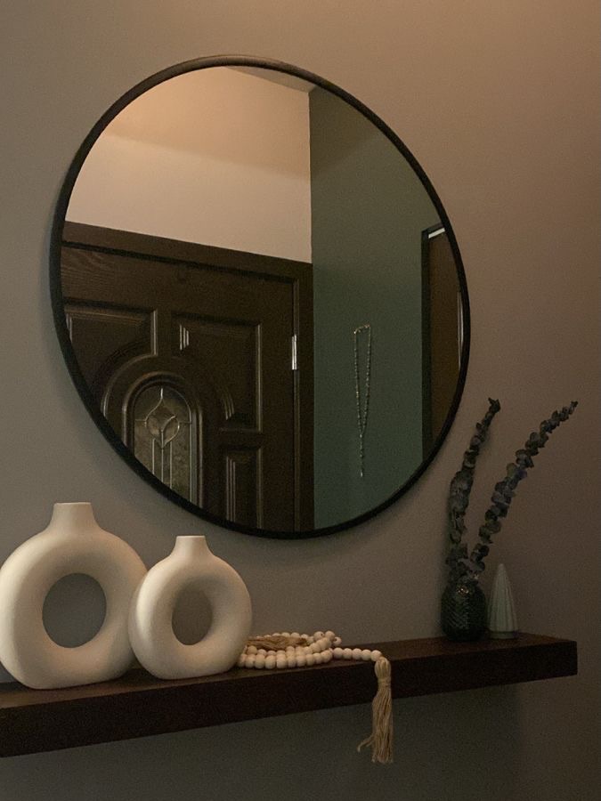 Elegant round mirror enhances minimalist decor