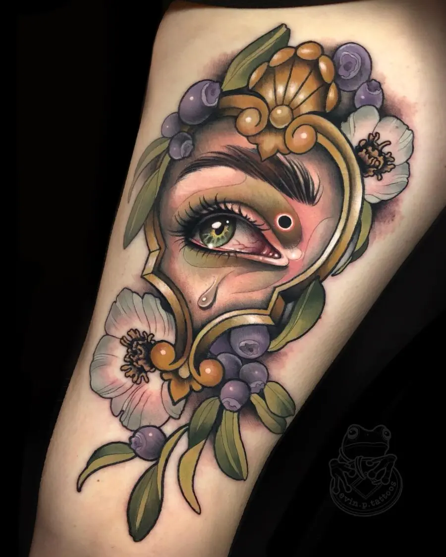 Intricate eye surrounded by floral elements.