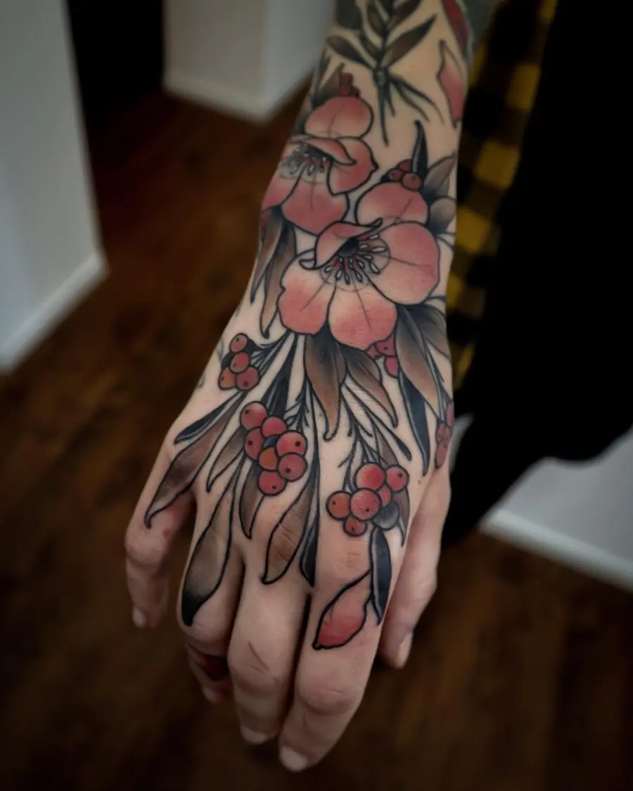 Vibrant floral neo traditional hand tattoo