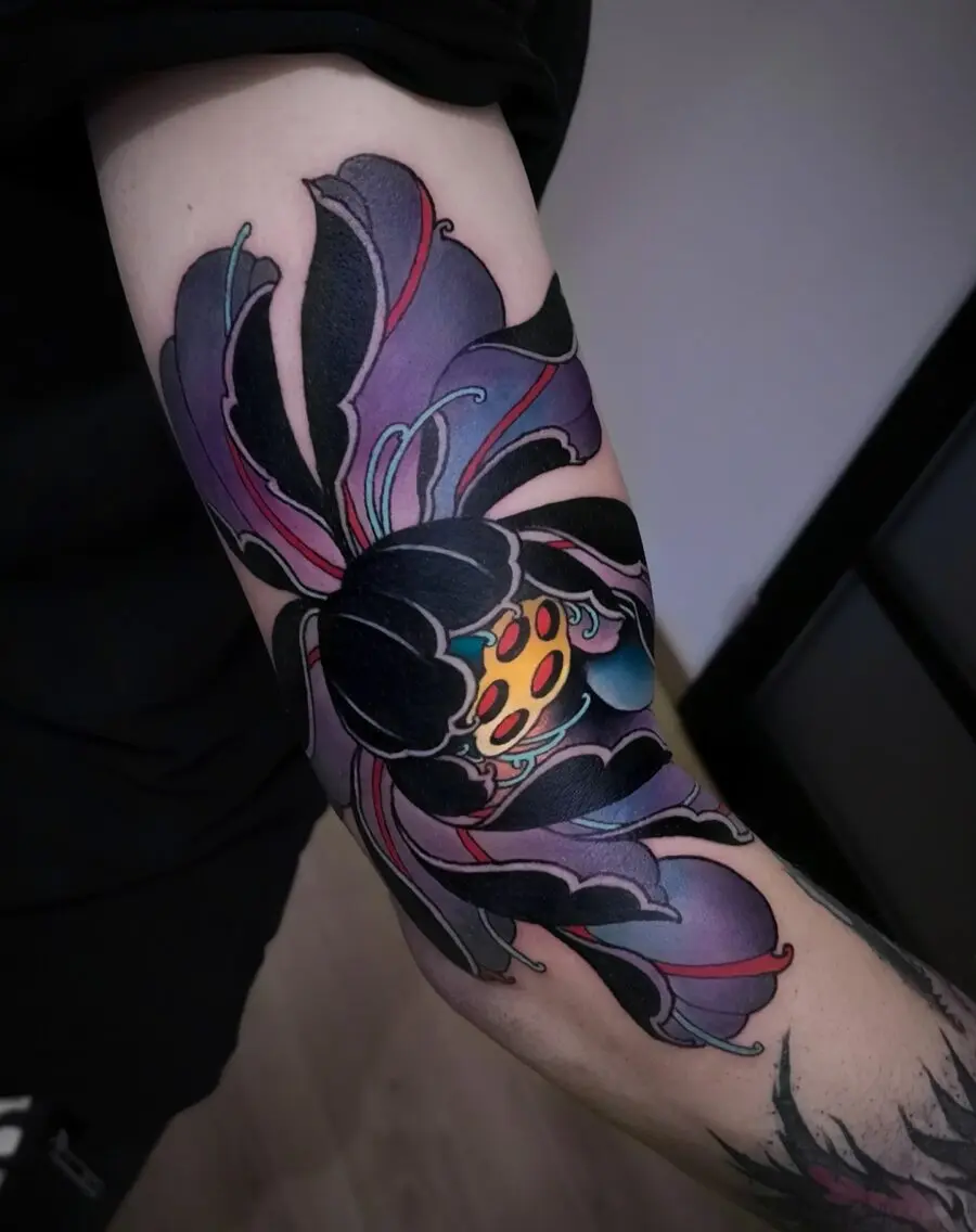 Vibrant neo-traditional flower tattoo with bold colors