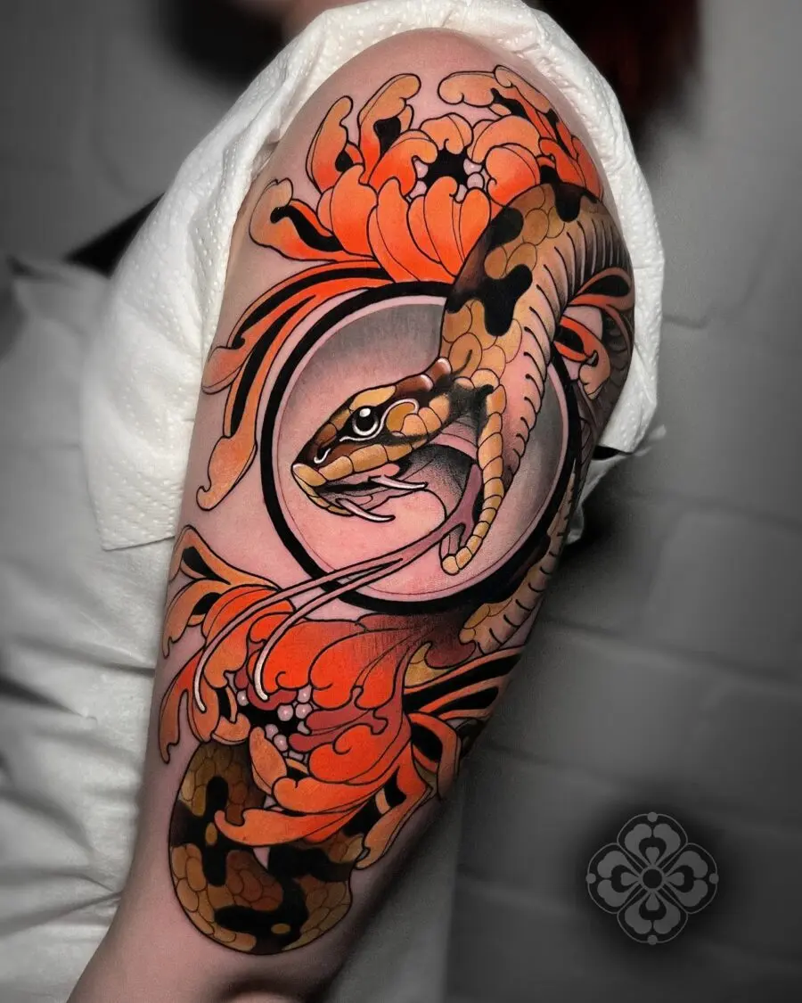 Striking neo-traditional snake and floral tattoo
