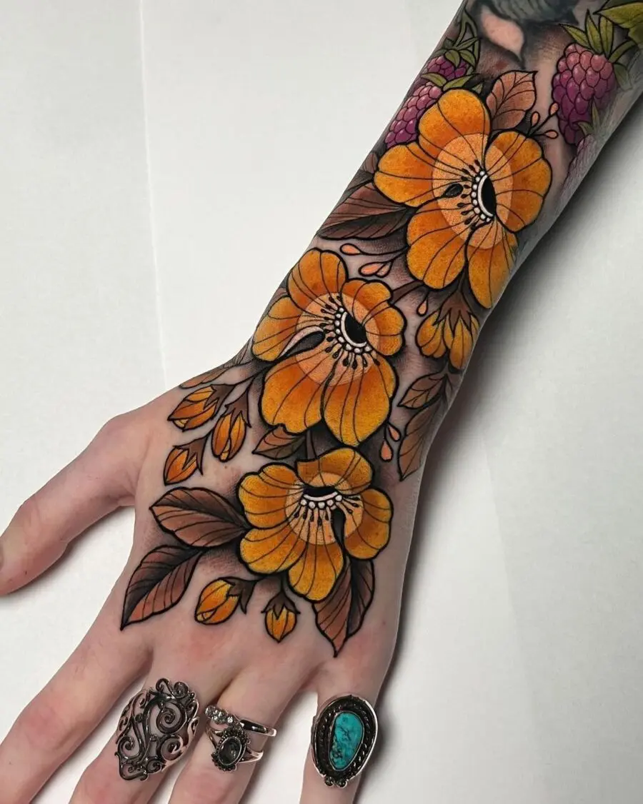Bold and colorful floral hand tattoo design