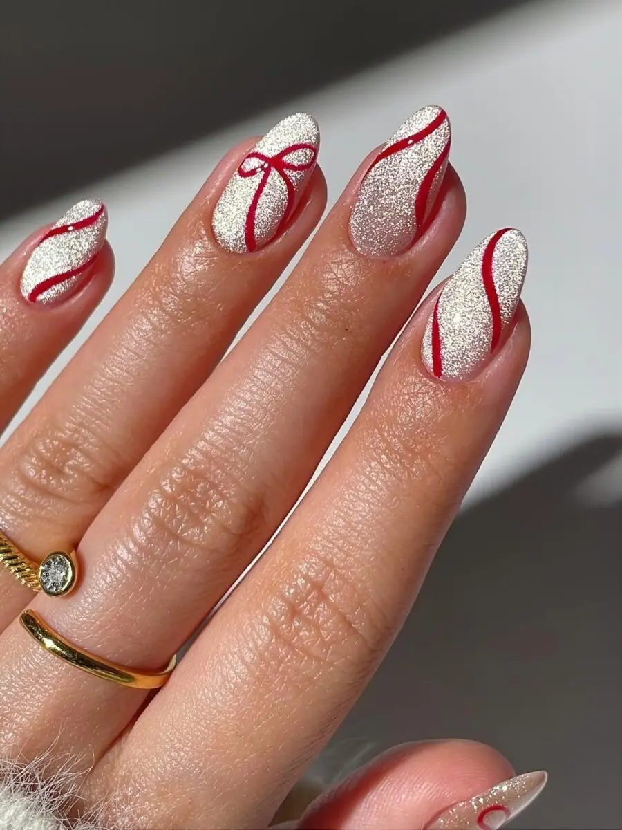 Sparkling white nails with festive red accents