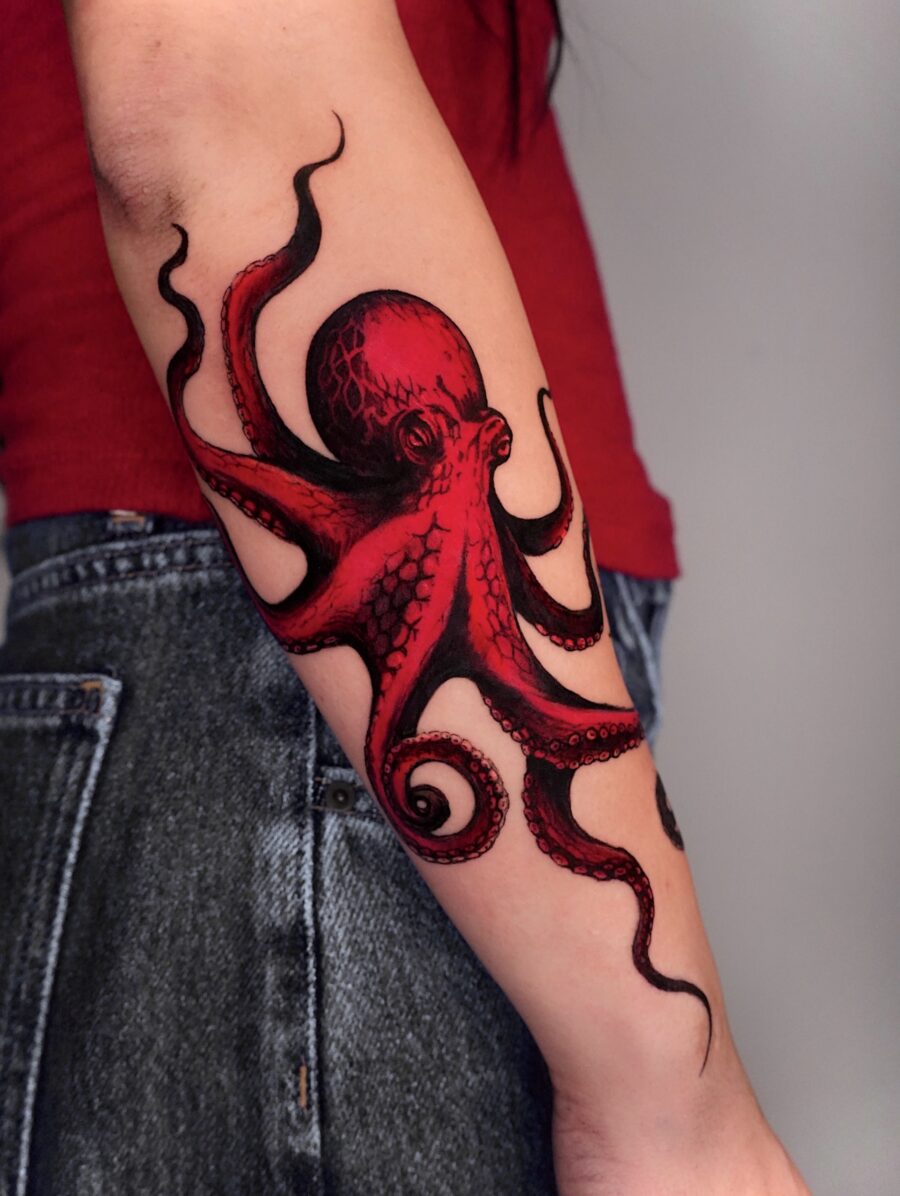 Striking red octopus tattoo showcases creativity