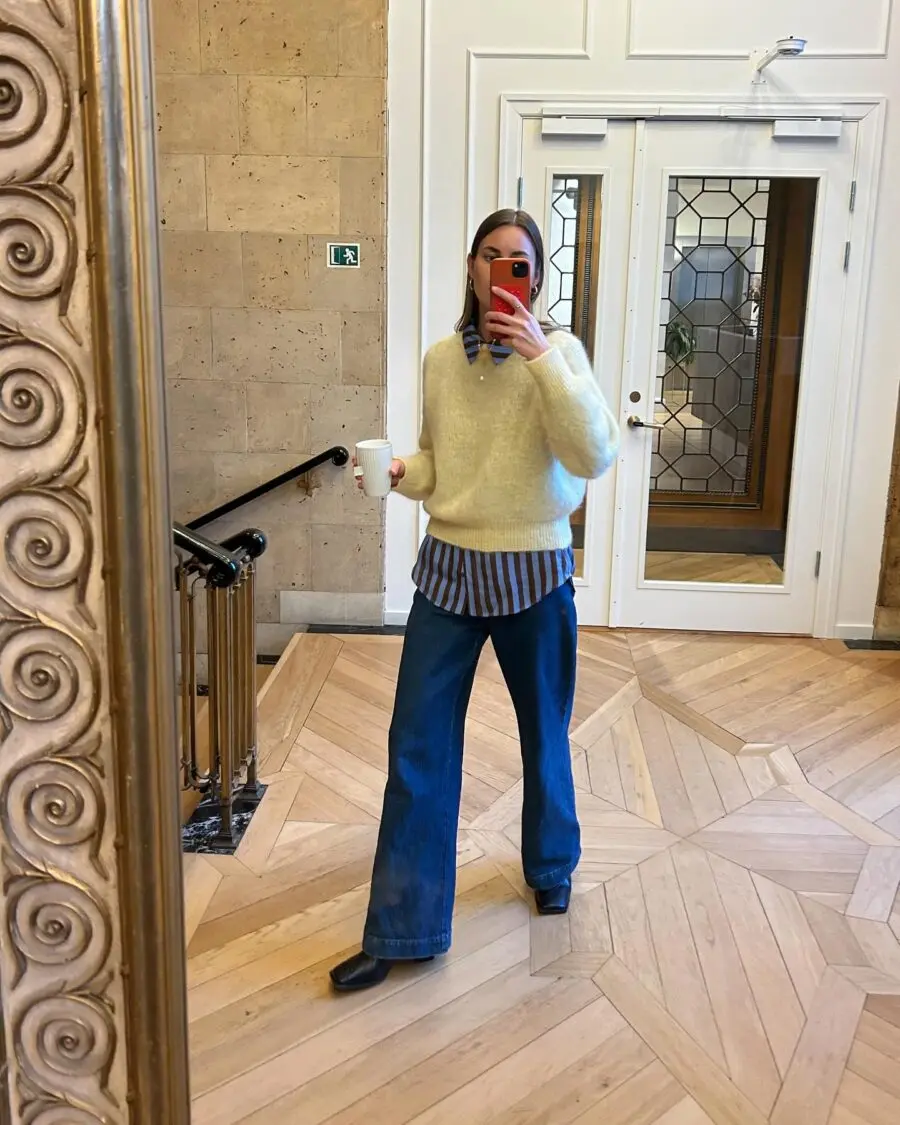 Chic office look with layered sweaters and jeans