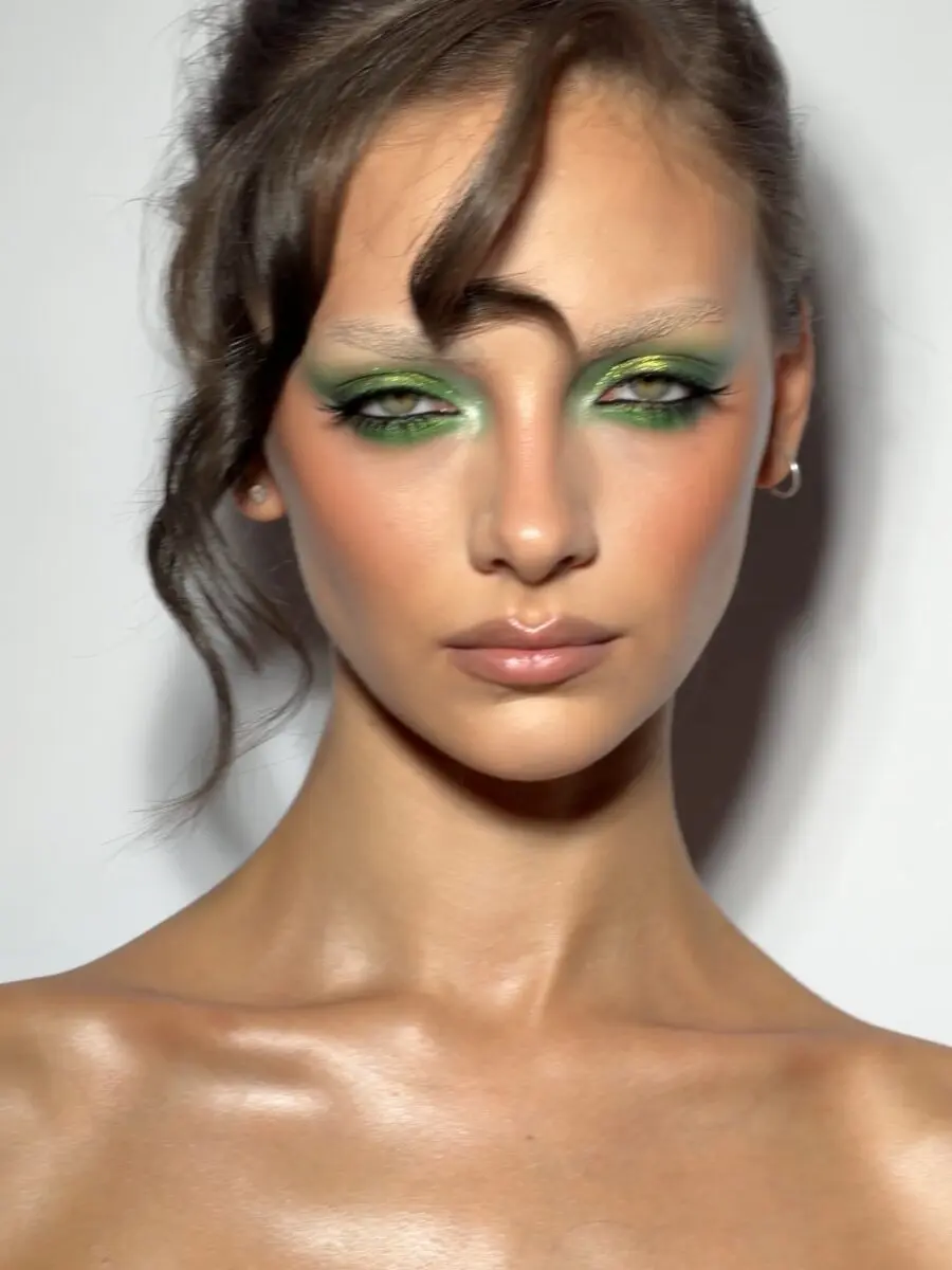 Vibrant green eyeshadow with glowing skin