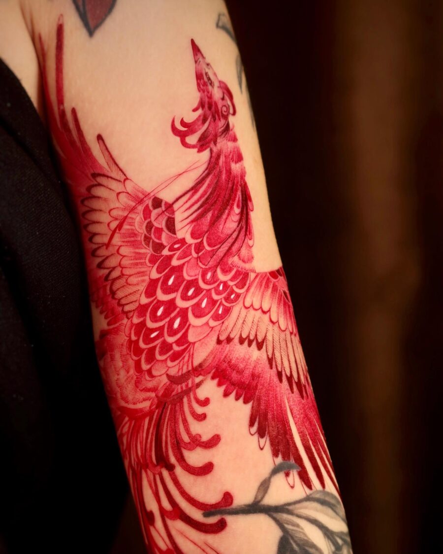 Vivid red ink bird tattoo design inspiration