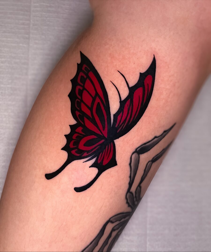 Striking red ink butterfly tattoo design
