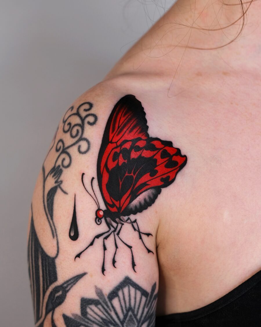 Stunning Red Ink Butterfly Tattoo on Shoulder