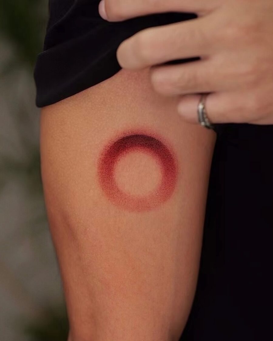 Bold Red Circle Tattoo on Arm
