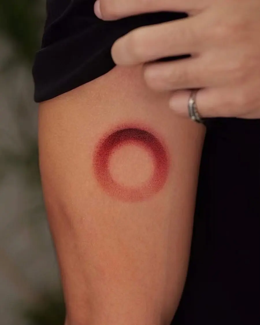 Bold Red Circle Tattoo on Arm