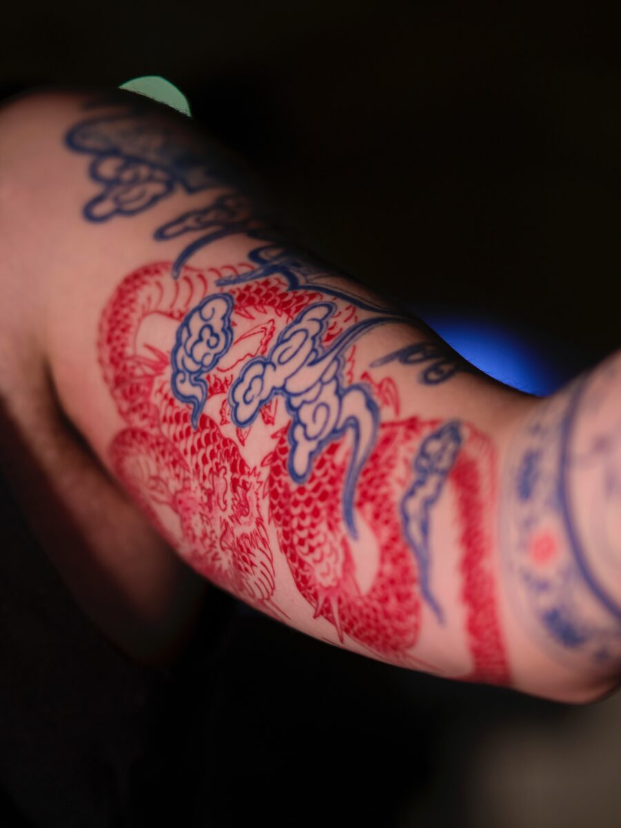 Intricate red ink dragon tattoo design