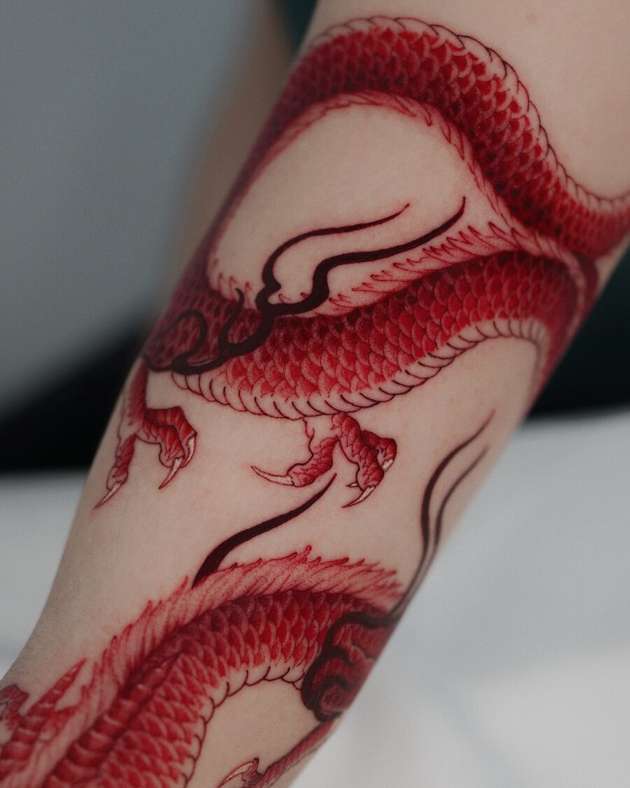Intricate red ink dragon tattoo detail