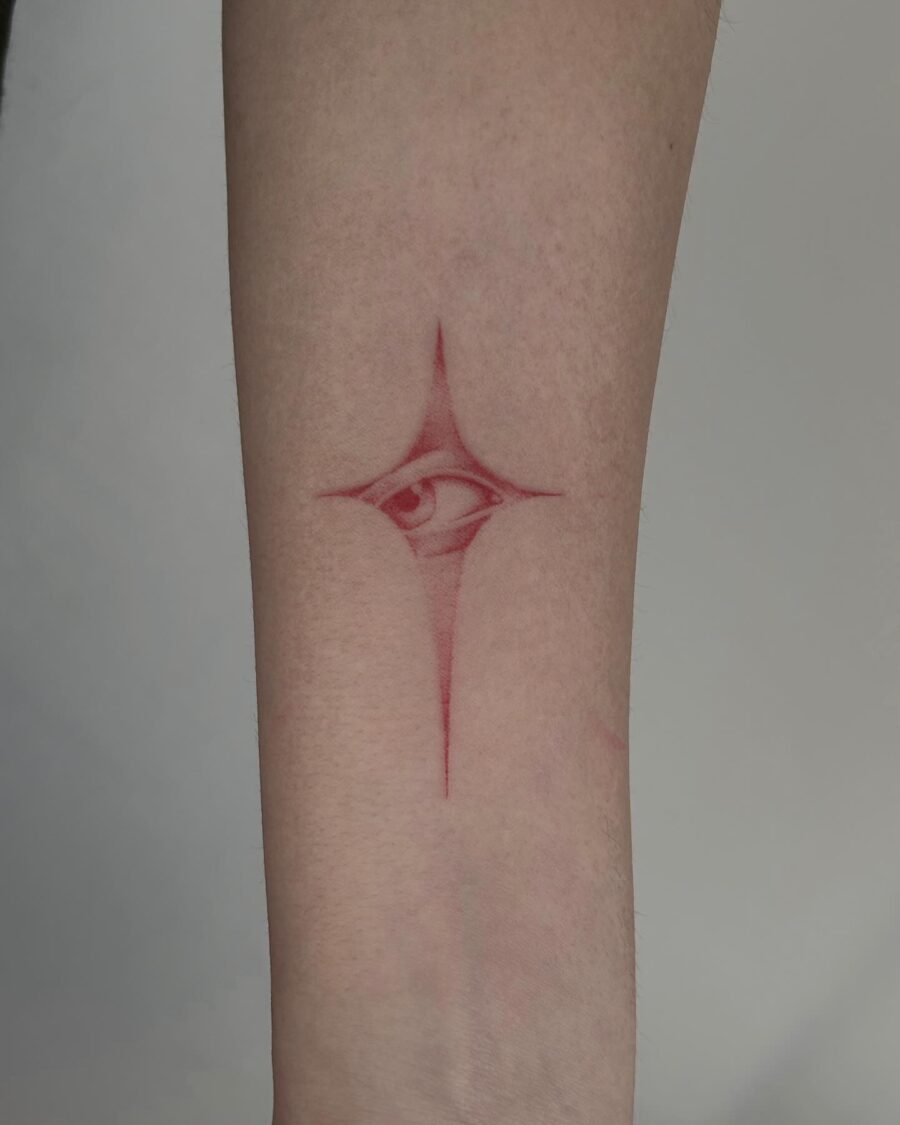 Intricate red ink eye tattoo design