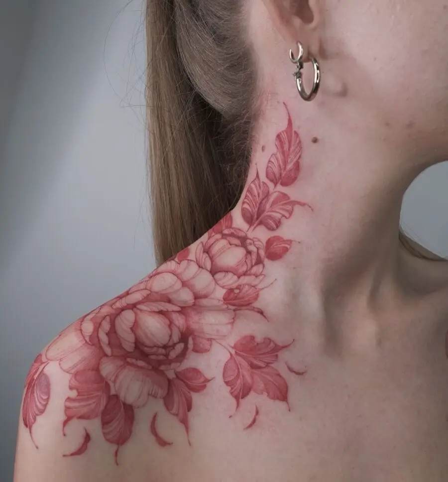 Elegant red ink floral tattoo on shoulder