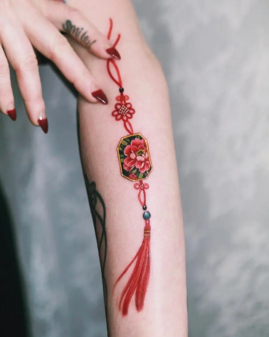 Vibrant red floral tattoo on the arm