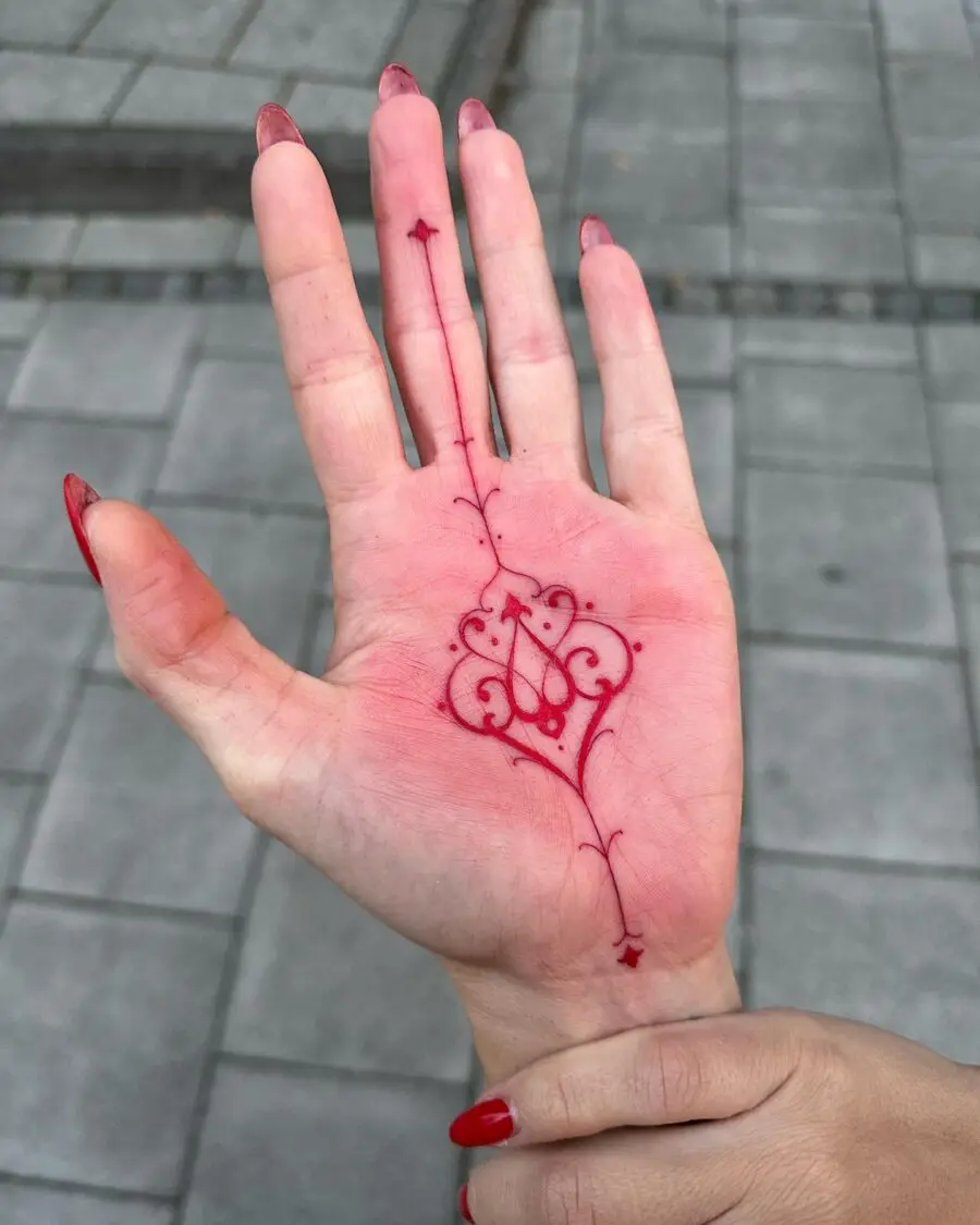 Intricate Red Ink Tattoo on the Palm