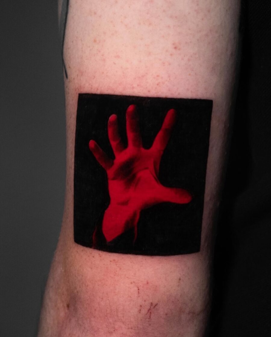 Striking red ink hand tattoo design