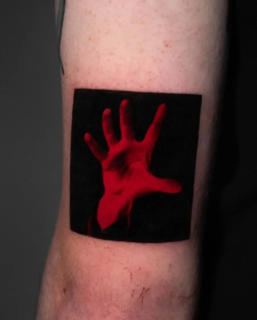 Striking red ink hand tattoo design