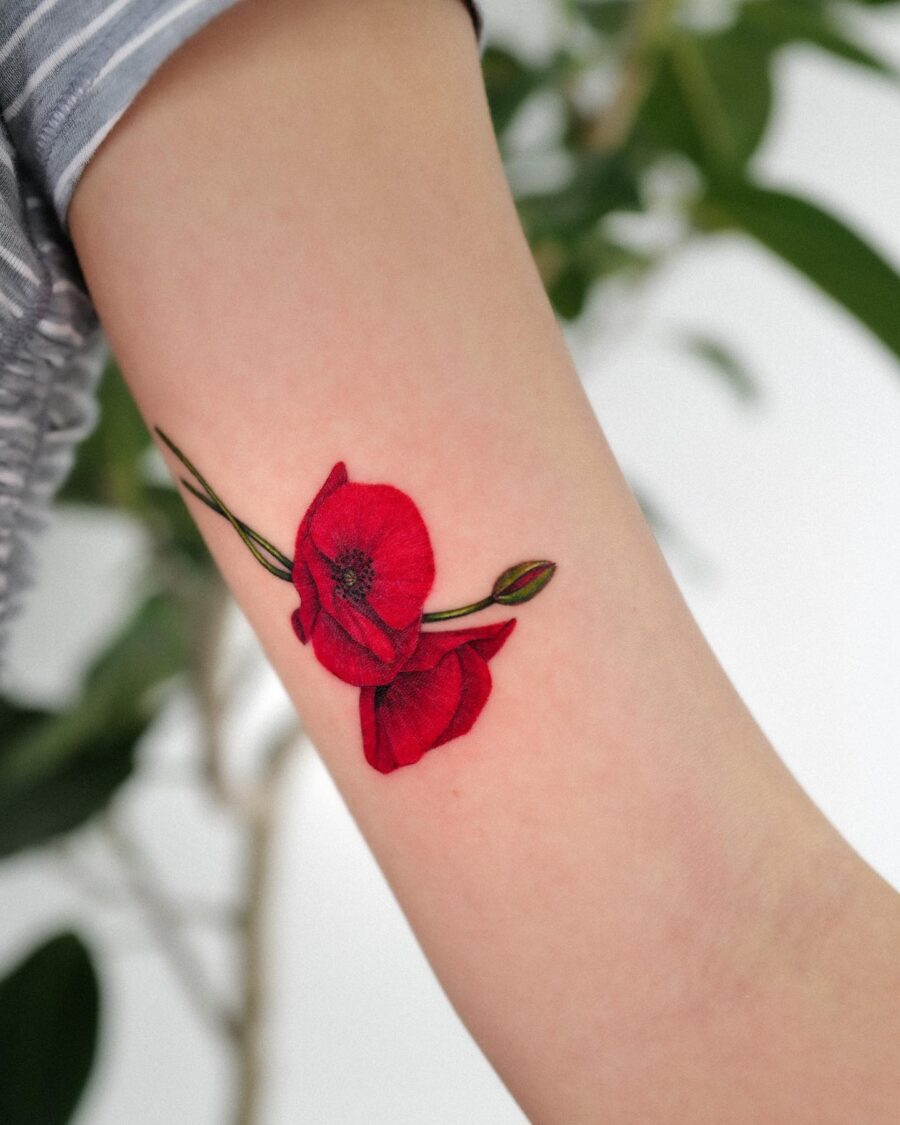 Vibrant red poppy ink design on skin