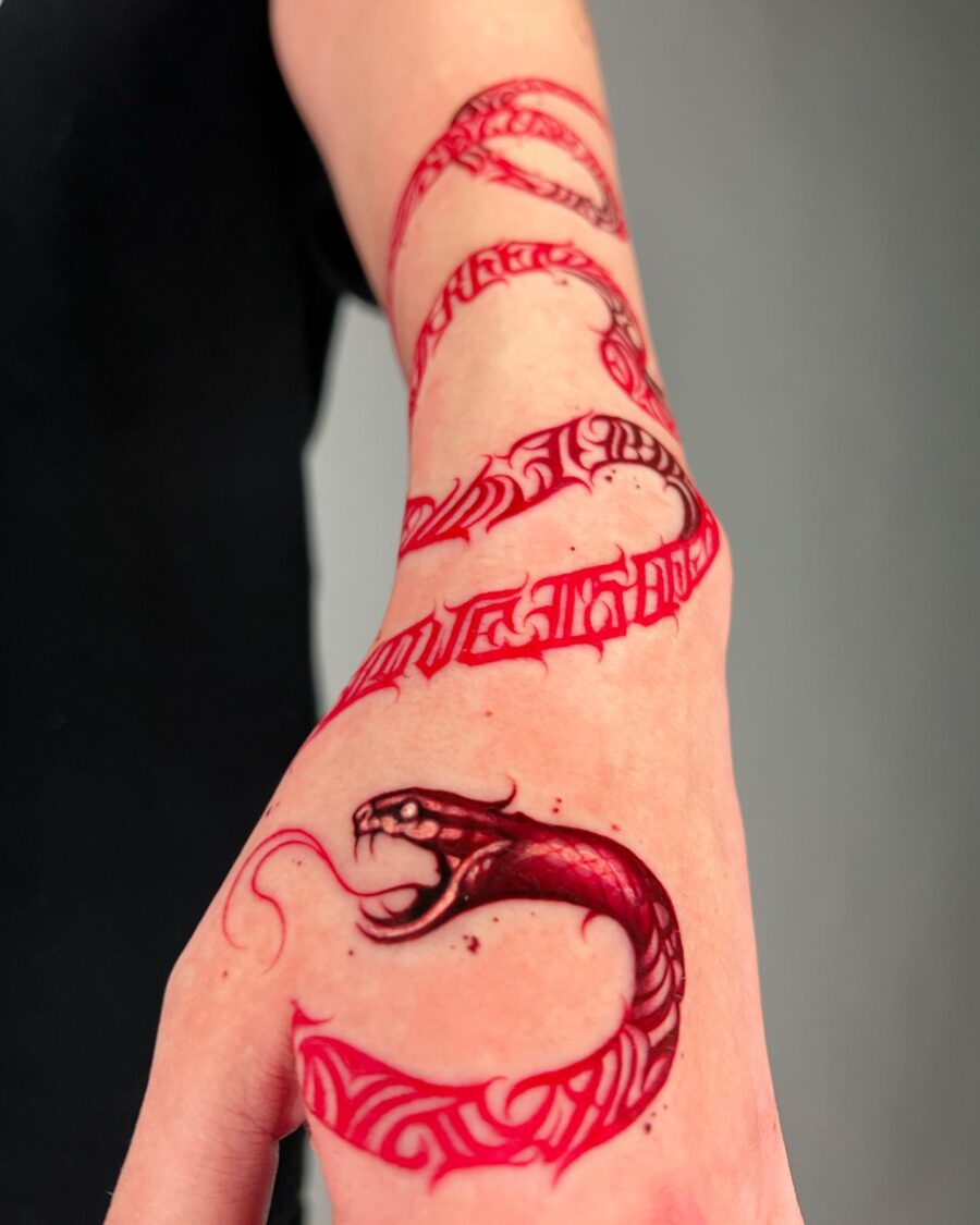 Intricate red ink snake tattoo design