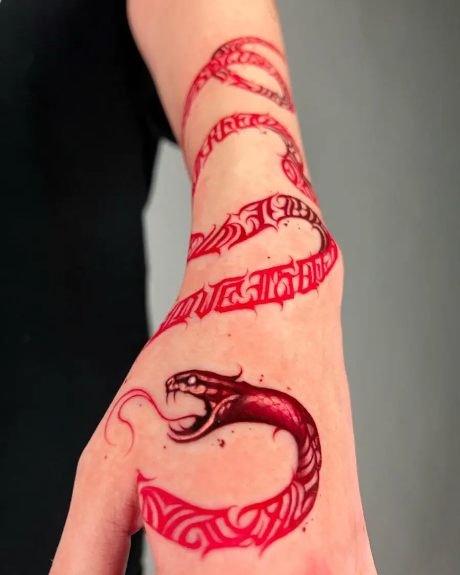 Intricate red ink snake tattoo design