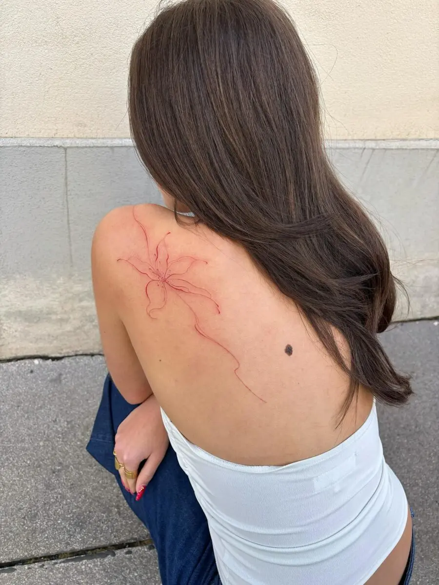 Elegant red ink spider tattoo on back