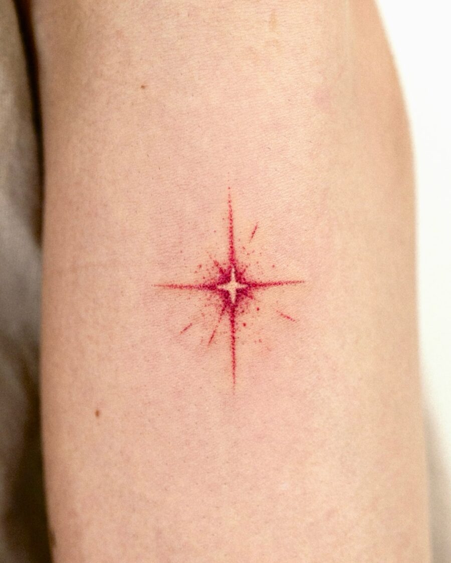 Bold red star tattoo on soft skin