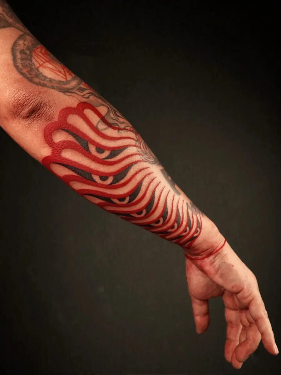 Striking Red Ink Tattoo on Forearm