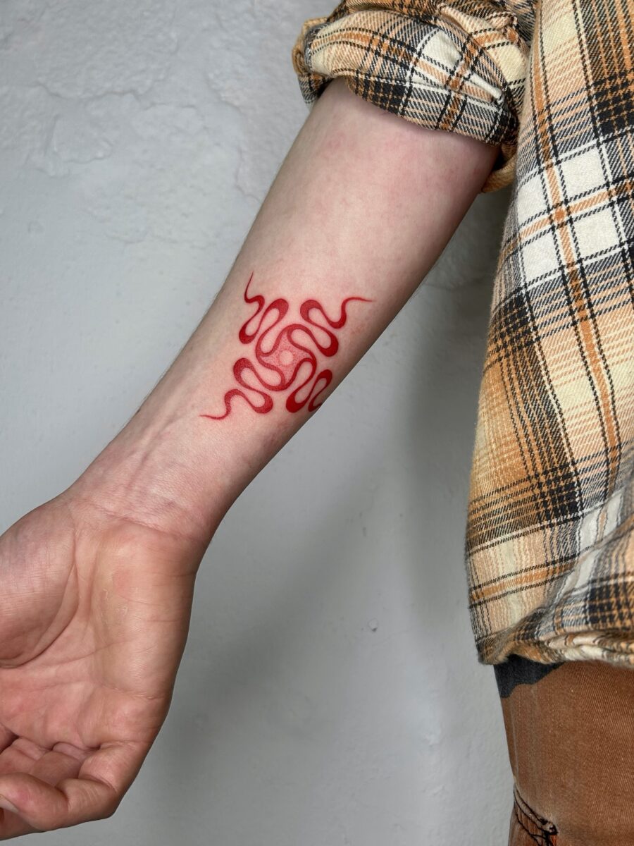 Fluid red lines create mesmerizing tattoo patterns