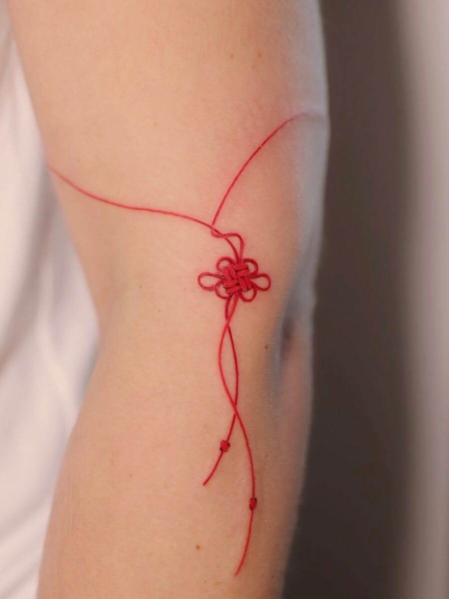 Delicate red ink flower tattoo concept