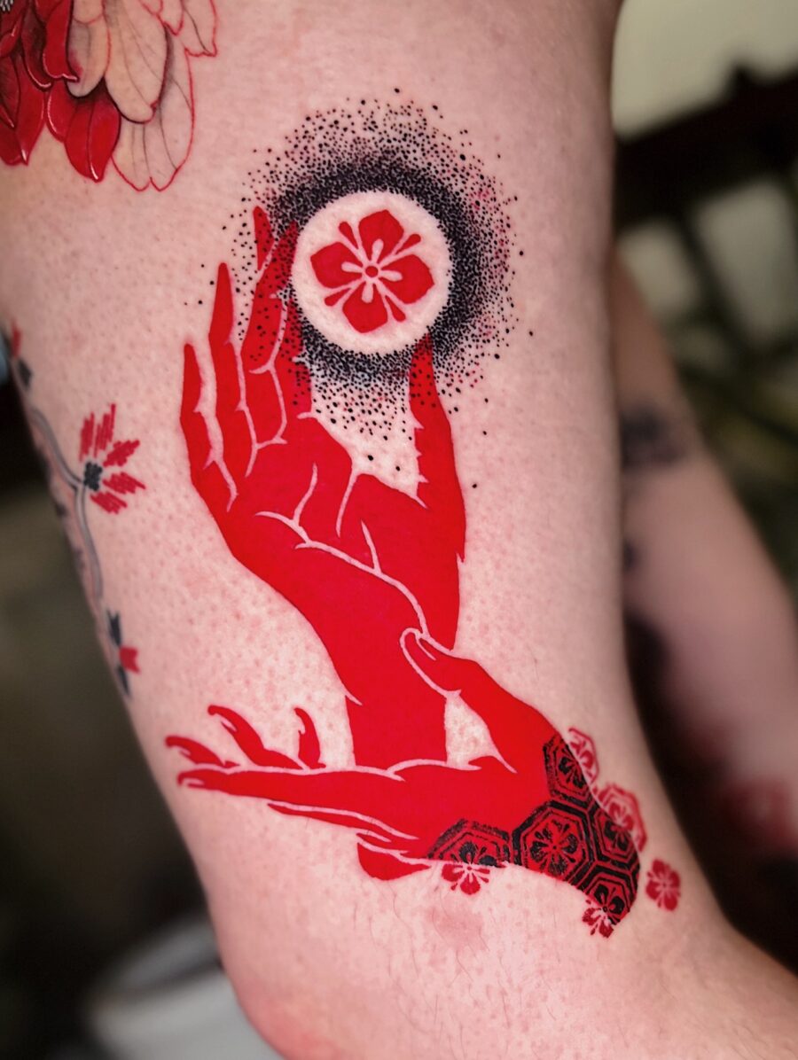 Vibrant red ink hand with floral elements