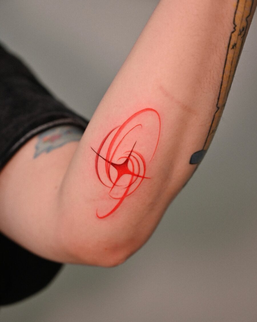 Elegant red ink tattoo with swirling patterns