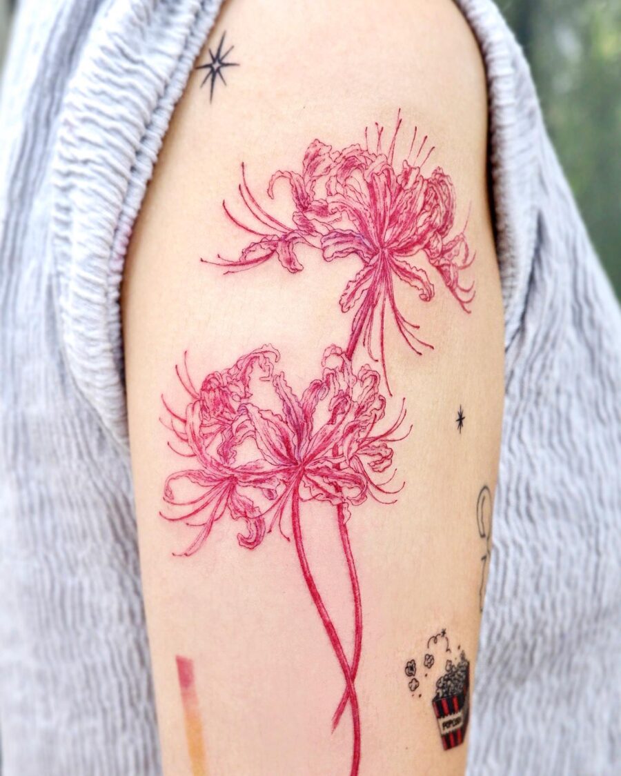 Elegant red ink floral tattoo on arm